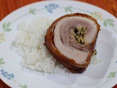 a white plate topped with meat and rice