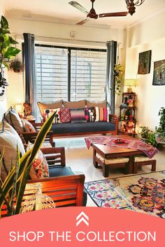 a living room filled with lots of furniture and plants