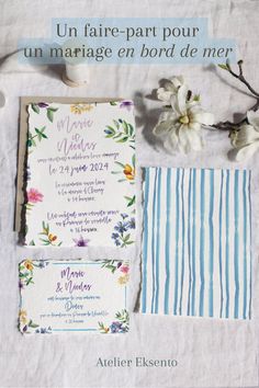 the wedding stationery is laid out with flowers