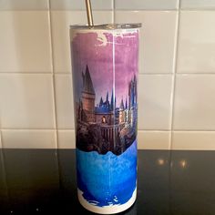 a purple and blue tumbler sitting on top of a counter