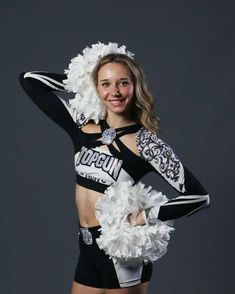 a cheerleader is posing for the camera