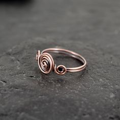 These rings are made with copper wire.  ✩ The item comes in a branded gift box- perfect for gifting.  ✩ All items are handcrafted by myself and every effort is taken to produce a high quality product.  ✩ If you have particular questions, send me a message! I am also doing jewelry upon request, so if you have an idea of what you want me to make for you, please get in touch to talk about it! Minimalist Rose Gold Spiral Jewelry, Handmade Minimalist Rose Gold Midi Rings, Hand Forged Adjustable Midi Rings As Gifts, Hand Forged Midi Rings As Gift, Minimalist Hand Forged Stackable Rings For Gift, Minimalist Hand Forged Stackable Rings As Gift, Adjustable Hand Forged Midi Rings As Gift, Elegant Wire Wrapped Midi Rings As Gift, Elegant Wire Wrapped Midi Rings For Gift