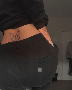 a woman's stomach with a butterfly tattoo on her lower body and bottom half