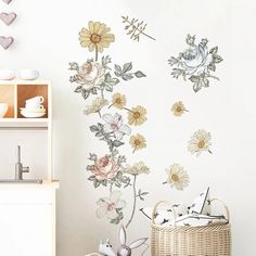 a wall with flowers painted on it in a room next to a wicker basket