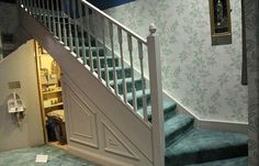 an open door leading to a stairway in a house with wallpaper on the walls