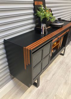 a record player is sitting on top of a black cabinet