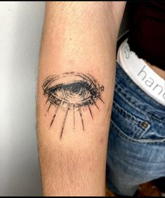 a person with a tattoo on their arm and an eye in the middle of it