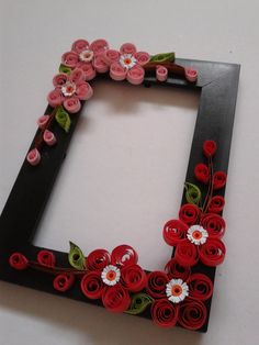 a photo frame made out of paper flowers