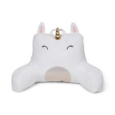 a white pillow with a unicorn face on the front and gold horns on the back