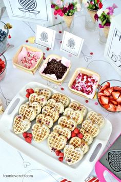 a table topped with waffles covered in fruit