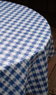 a blue and white checkered tablecloth on a wooden deck