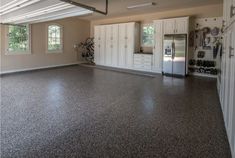 an empty garage with white cabinets and gray flooring is pictured in this image from the inside