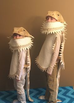 two children in costumes made to look like they are wearing fish tails