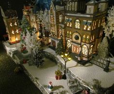 a christmas village with lit up trees and buildings