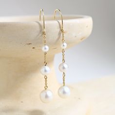 Prized for their beauty and elegance, these pearl chain earrings are a sophisticated addition to your wardrobe. With a subtle movement, these pearls are fit for any bridal or everyday sophisticated look. Classic Yellow Gold Chandelier Earrings, Elegant Pearl Earrings With Pearl Pendant, Elegant Pearl Earrings With Pendant, Elegant Pearl Embellished Drop Earrings, Elegant Pearl Bridal Earrings, Timeless Pearl Chain Earrings As Gift, Elegant Pearl Earrings With Pearl Chain, Timeless Pearl Chain Earrings For Gift, Minimalist Pearl Drop Earrings For Evening