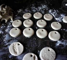 some white cookies are sitting on a table