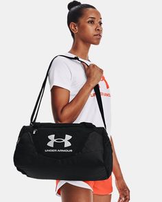 a woman carrying a black under armour gym bag