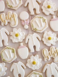 decorated cookies are arranged in the shape of baby's first year and their names