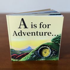 a is for adventure book sitting on a table