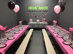 the tables are decorated with zebra print and pink tablecloths