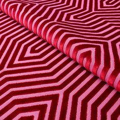 a red and white rug with lines on it