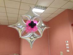 an office decorated with pink and silver balloons in the shape of a flower hanging from ceiling