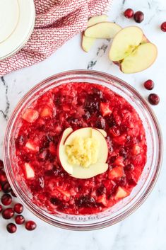 cranberry sauce in a food processor with apples and cherries around the bowl