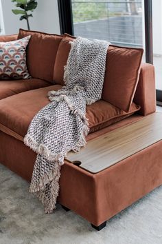 a living room with a couch and ottoman