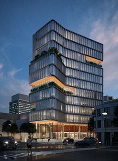 the building has many windows and plants growing on it's sides, while people walk by