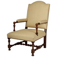 an old fashioned wooden chair with beige upholstered fabric and wood trimmings