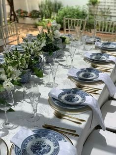 a table set with blue and white china