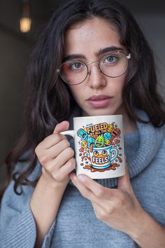 a woman wearing glasses holding a coffee mug