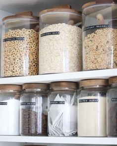 the shelves are filled with various types of cereals and other things in glass containers