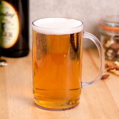 two mugs of beer sitting on top of a wooden table