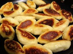 some dumplings are cooking in a pan on the stove and ready to be cooked