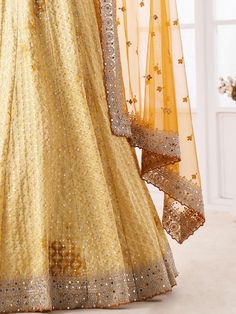 Precise beauty can come out from your dressing trend with this charming yellow lehenga choli in georgette material embellished with sequin, dori, stonework, and zarkan work. This beautiful yellow sequin lehenga comes with similar color blouse material adorned with the same design as the lehenga and comes with a similar color dupatta with dori, sequin, and stonework with zarkan. This yellow engagement wear lehenga is semi-stitched up to 42 inches and comes with fully unstitched blouse material. N Semi-stitched Sets For Wedding And Festivals, Festive Long Lehenga With Dori Work, Full Length Lehenga With Resham Embroidery For Reception, Semi-stitched Full Length Lehenga With Resham Embroidery, Semi-stitched Long Choli With Zari Work, Festive Full-length Lehenga With Resham Embroidery, Semi-stitched Full-length Lehenga With Resham Embroidery, Festive Full Length Lehenga With Resham Embroidery, Long Semi-stitched Choli With Zari Work