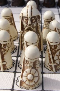 a chess board with white and brown figures on it