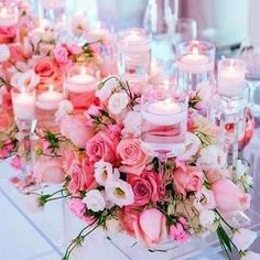 a long table with candles and flowers on it