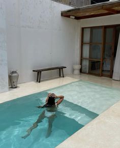 a woman sitting in the middle of a swimming pool