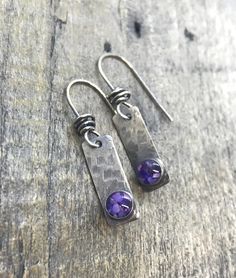 "Textured sterling silver rectangles with glass cabs with a mix of purple hues. The drops measure 1/4\"wide x 3/4\"long.  All pieces are created entirely by me in my MN studio. The ear-wires are all hand wrapped to each piece, and are finished with a hand applied patina.  Created in a smoke-free, pet-free environment." Modern Purple Metal Jewelry, Modern Purple Dangle Jewelry, Nickel-free Rectangular Sterling Silver Earrings, Silver Oblong Everyday Jewelry, Handmade Modern Jewelry With Rectangular Stone, Silver Jewelry With Rectangular Pendant And Matching Earrings, Everyday Silver Oblong Jewelry, Hypoallergenic Square Sterling Silver Jewelry, Silver Jewelry Set With Rectangular Pendant And Matching Earrings