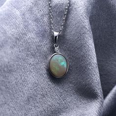 925 Sterling Silver Natural Australian Crystal White Opal Pendant Necklace | October Birthstone | Fine Gemstone Jewelry | Gift Opal is the queen of gemstone, which is one of the most beautiful gemstones in the world. Every piece of opal is unique. Its optical effect is Play-of-Color, which shows a vivid play of iridescent color. The colors change when the stone is viewed with various angles. We only use natural opal (no synthetics) for our jewelry. This elegant pendant necklace is simple, delica White Gold Opal Jewelry With Birthstone, Opal Jewelry With Gemstone Accents For Formal Occasions, Elegant Opal Jewelry With Cabochon, Formal Opal Jewelry With Gemstone Accents, Elegant Opal Cabochon Jewelry, Exquisite Silver Necklace With Polished Finish, Elegant White Gold Opal Jewelry, Luxury Opal Gemstone Necklaces, Luxury Opal Gemstone Necklace