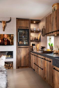 a kitchen with wooden cabinets and an animal head mounted on the wall