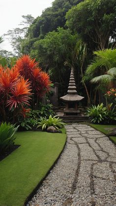 a stone path leads to a pagoda surrounded by tropical plants and trees in the background