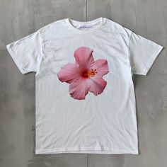 Hibiscus Classic Unisex Tee Hibiscus Classic Unisex Tee, Heavy Cotton Graphic T-Shirt, Iconic Slogan Print - 100% cotton - Classic Unisex fit - Runs true to size (refer to size chart) - Tear-away label - Y2K Vintage Streetwear Trending Fashion - Environmentally sustainable made-to-order system Please refer to the size chart in the listing photos for more sizing details. Don't forget to tag us in any photos or videos :) White Hibiscus Print T-shirt For Spring, Hawaiian Cotton Tops With Hibiscus Print, Hawaiian Cotton Tops With Print, Cotton Hawaiian Tops With Hibiscus Print, Hawaiian Cotton Printed Tops, Hawaiian Printed Cotton Tops, Hawaiian Style Printed Cotton Tops, Casual Floral Print T-shirt For Streetwear, Pink Hawaiian Short Sleeve T-shirt