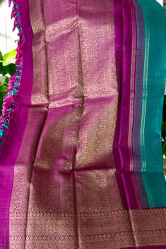 This banarasi inspired stunning kanjivaram saree in turquoise blue shot with black is handwoven with yazhi and horse motifs in gold zari on the body. The borders in magenta purple have traditional motifs like floral, chakras and geometric patterns in gold zari. The grand pallu in magenta purple color mirrors the patterns of the borders in gold zari. Approximate Length 6.5 mtrs (inclusive of blouse length) Approximate weight - 1.5 lbs Approximate Height - 48 - 52" Saree comes with fall, picot and tassels done when applicable. Blouse piece is cut. Kindly Note : The colors you see on your device may vary due to the color reproduction, brightness and resolution of individual devices. If you'd like more clarity before your purchase, please contact our support team Blue Shots, Horse Motif, Kanjivaram Saree, Kanjivaram Silk Saree, Magenta Purple, Traditional Motifs, Silk Cotton Sarees, Kanjivaram Sarees, Cotton Sarees