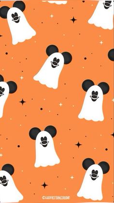 an orange background with black and white mickey mouse heads