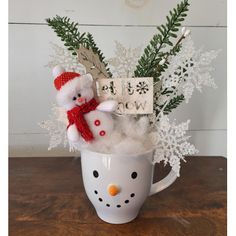 a snowman in a mug with a happy new year sign