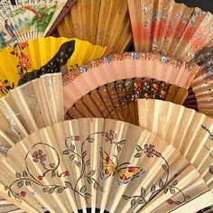 many different types of hand fans with designs on them