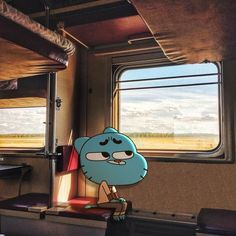 a cartoon character standing in front of a window on a train with the sky outside