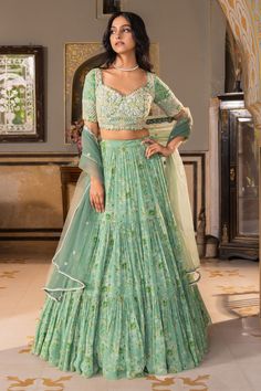 Green georgette tiered lehenga with attached can-can and all over woven floral pattern. Paired with sweetheart neck padded blouse with all over pearl, bead, cut dana, sequin hand embroidery and net embroidered dupatta.
Components: 3
Pattern: Woven and Embroidered
Type Of Work: Floral Pattern, Bead, Pearl, Cut Dana and Sequin Work
Neckline: Sweetheart Neck
Sleeve Type: Half Sleeves
Fabric: Georgette, Net, Lining: Santoon
Color: Green
Other Details: 
Embroidered cut work border on dupatta
Pleated Off Shoulder Lehenga, Lehenga Styles, Tiered Lehenga, Layered Lehenga, Ruffle Lehenga, Lehenga Pattern, Raw Silk Lehenga, Lehenga Designs Simple, Traditional Blouse Designs